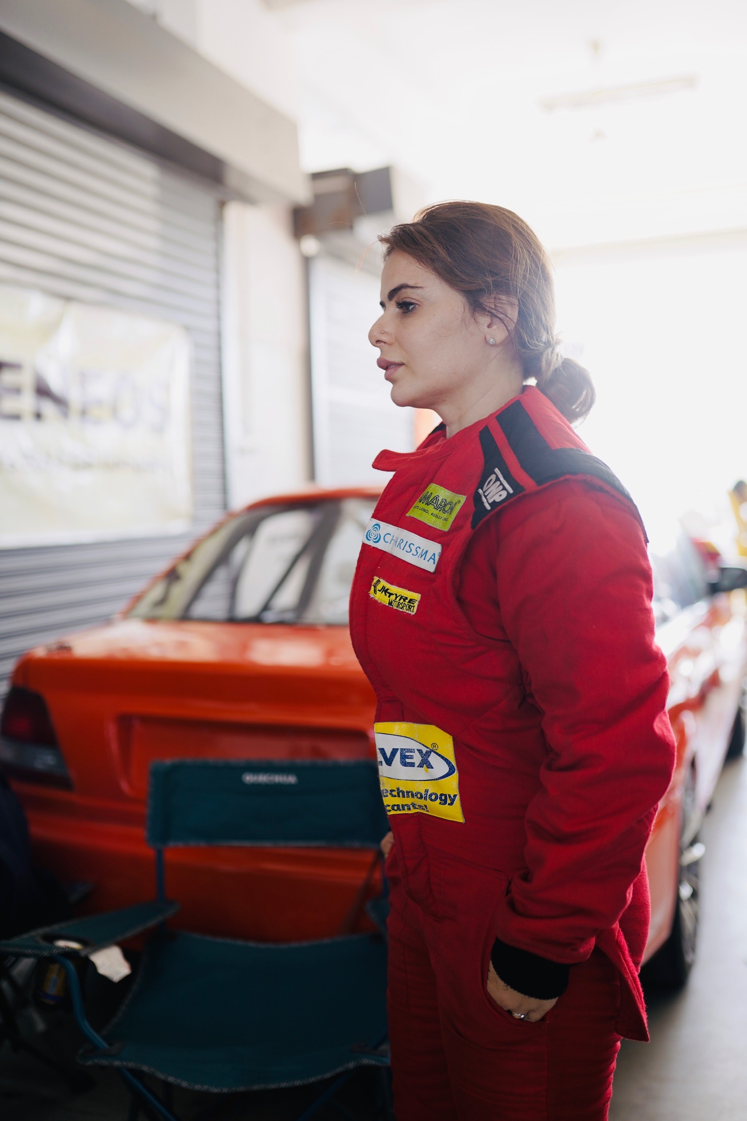 Alisha in red suit – side profile